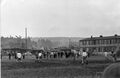 Fußballspiel in der Eschenau zwischen dem BSC Fürth West und der DJK Fürth. Im Hintergrund links ist der gesprengte Bunker zu erkennen. Rechts ein Haus der Eschenausiedlung, Mrz 1958